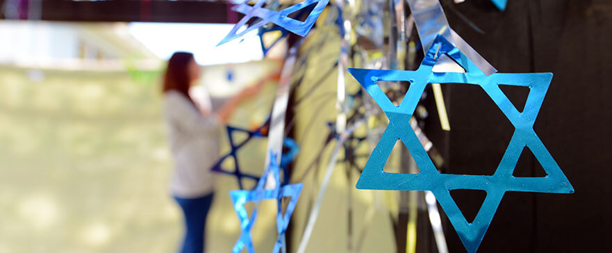 Jewish woman decorating here family Sukkah for the Jewish festival of Sukkot. A Sukkah is a temporary structure where meals are taken for the week.